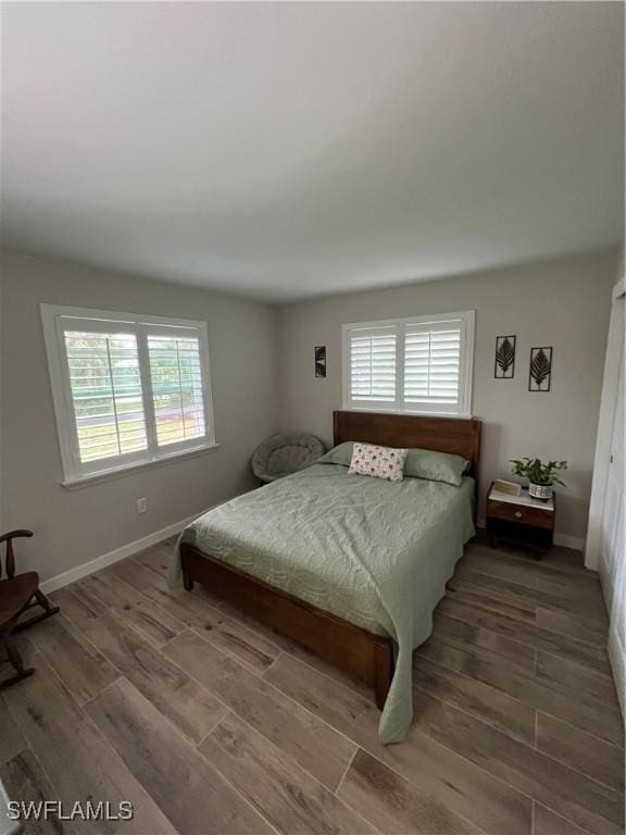 3680 Woodstork Ct, Fort Myers, FL 33908 - bedroom with baseboards and wood finished floors