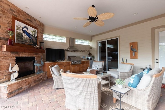 interior space featuring ceiling fan and an outdoor stone fireplace