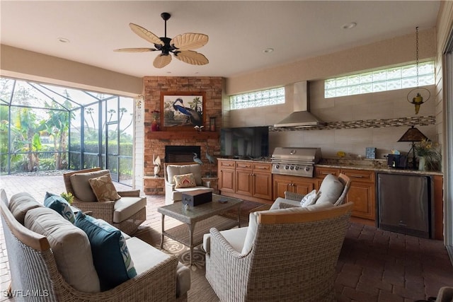 living room featuring ceiling fan and a fireplace