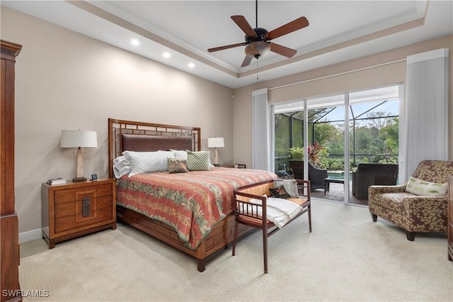 bedroom with a tray ceiling, access to exterior, and light carpet