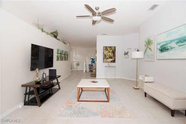 living room with ceiling fan and light tile patterned floors