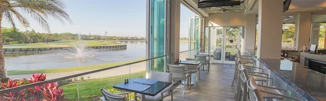 sunroom / solarium with a water view