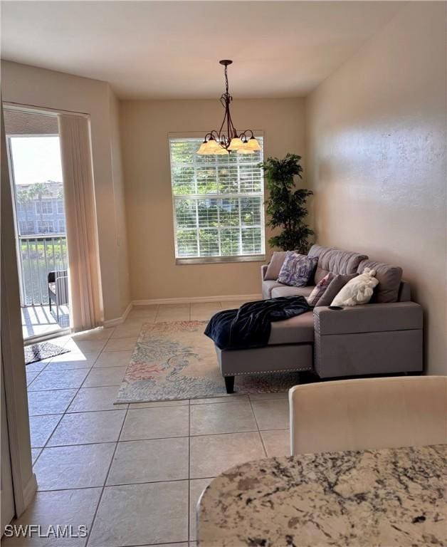10007 Sky View Way Unit 2005, Fort Myers, FL 33913 - living room featuring healthy amount of natural light, light tile patterned flooring, and a chandelier