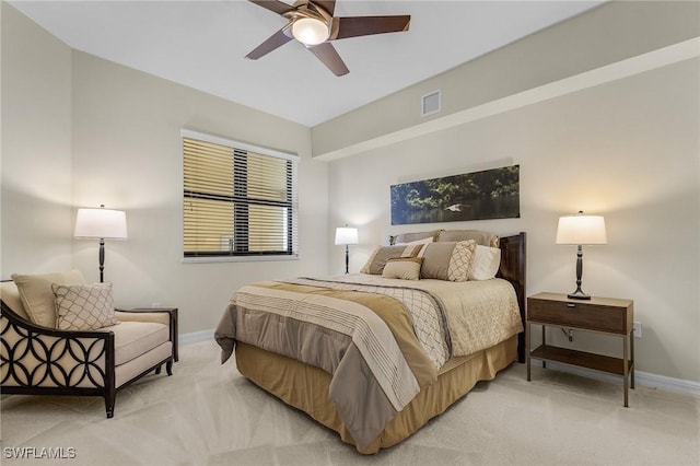 bedroom featuring baseboards, ceiling fan, visible vents, and light colored carpet