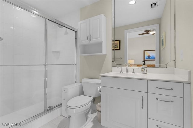 bathroom with vanity, visible vents, toilet, and a shower stall
