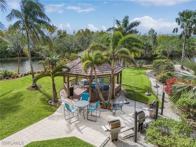 view of patio featuring a gazebo and a water view