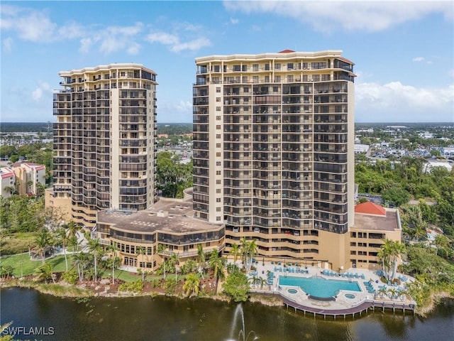 view of property with a water view and a city view
