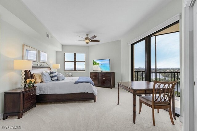 bedroom with access to exterior, light colored carpet, visible vents, and ceiling fan