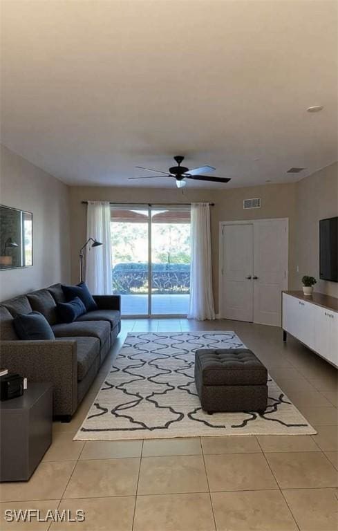 tiled living room with ceiling fan