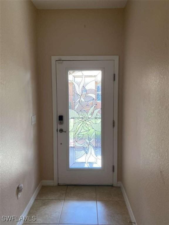 13772 Cleto Dr, Estero, FL 33928 - doorway featuring baseboards and light tile patterned floors