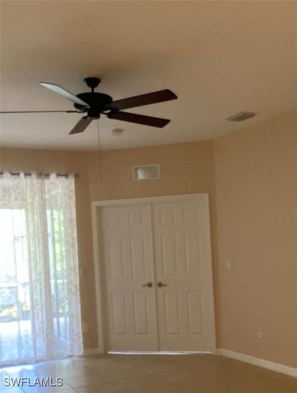 13772 Cleto Dr, Estero, FL 33928 - unfurnished bedroom featuring a ceiling fan, baseboards, visible vents, and a closet