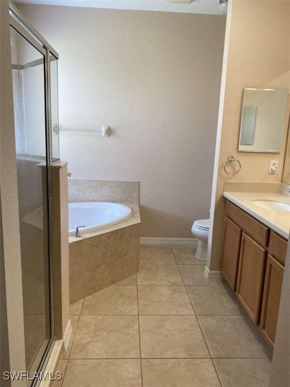 13772 Cleto Dr, Estero, FL 33928 - bathroom with toilet, tile patterned floors, a garden tub, vanity, and a shower stall