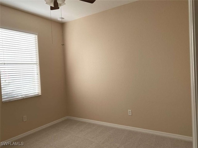 13772 Cleto Dr, Estero, FL 33928 - empty room with light carpet, ceiling fan, baseboards, and a wealth of natural light