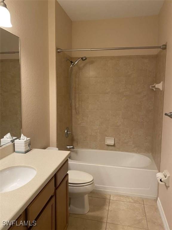 13772 Cleto Dr, Estero, FL 33928 - bathroom featuring shower / bathing tub combination, vanity, toilet, and tile patterned floors