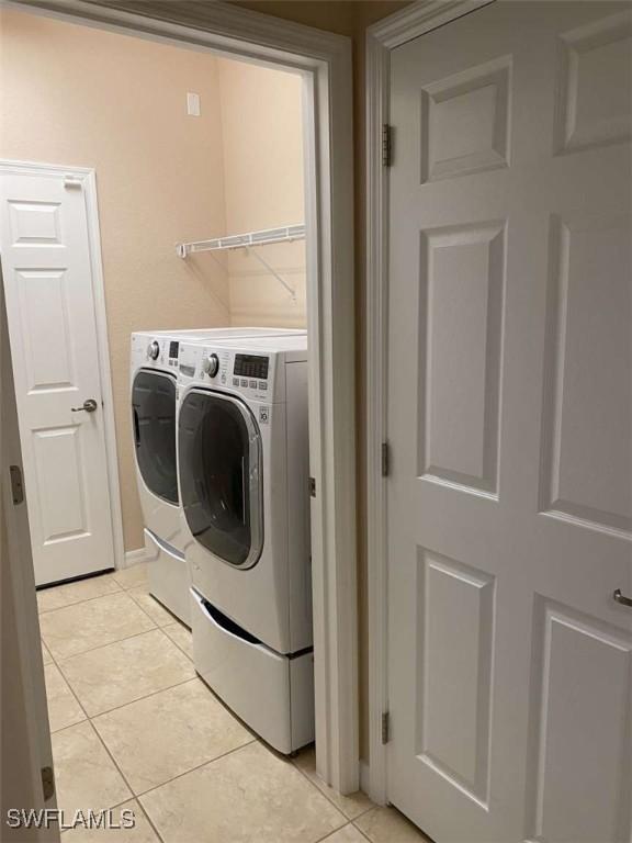 13772 Cleto Dr, Estero, FL 33928 - laundry area featuring laundry area, independent washer and dryer, and light tile patterned flooring