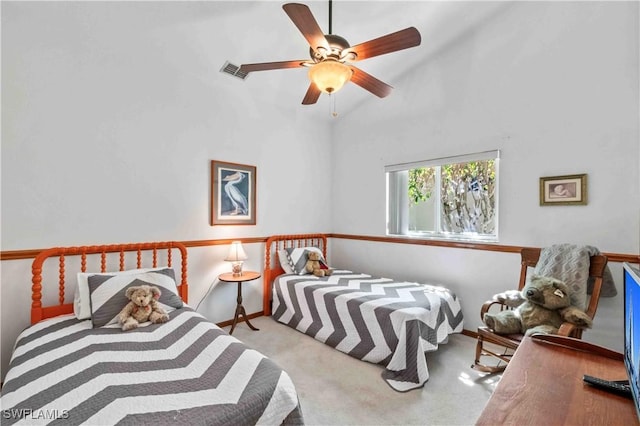 carpeted bedroom with a ceiling fan, visible vents, and baseboards