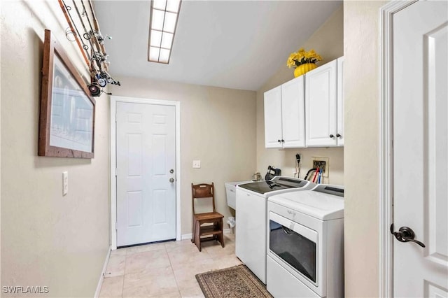 laundry area with cabinet space, light tile patterned floors, baseboards, independent washer and dryer, and a sink