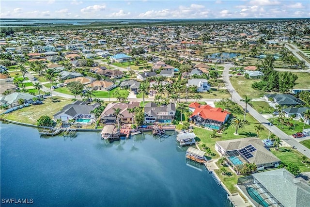 drone / aerial view with a water view and a residential view