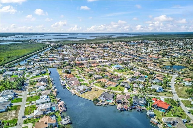 birds eye view of property featuring a water view and a residential view