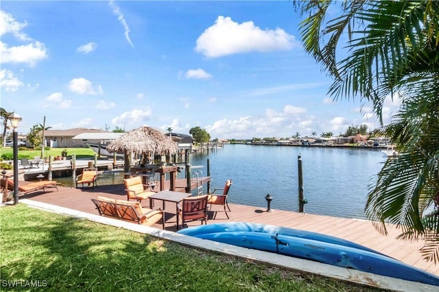 view of dock featuring a water view and a lawn