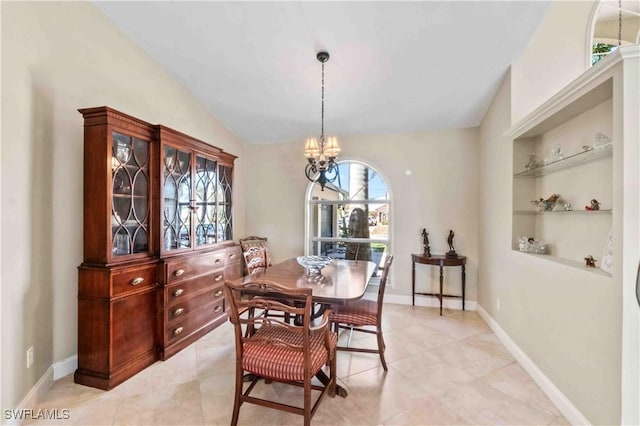 dining area featuring vaulted ceiling, built in shelves, baseboards, and a notable chandelier