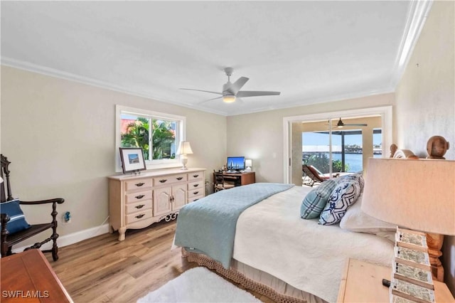 bedroom featuring access to exterior, multiple windows, ornamental molding, and light wood finished floors