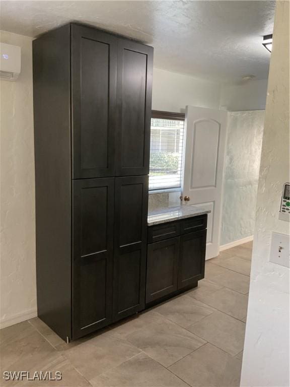 kitchen featuring an AC wall unit