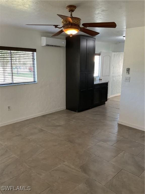 unfurnished room featuring ceiling fan and a wall mounted air conditioner