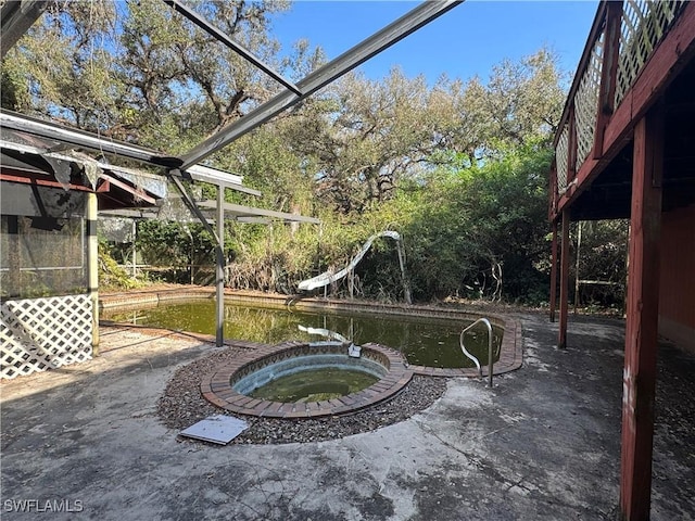 view of yard with an in ground hot tub and a patio