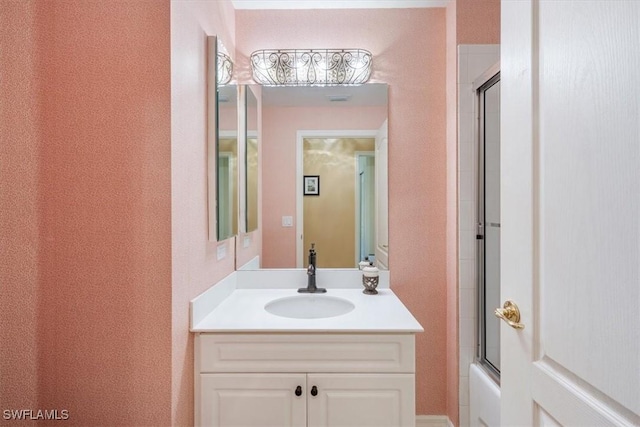 bathroom featuring vanity and combined bath / shower with glass door