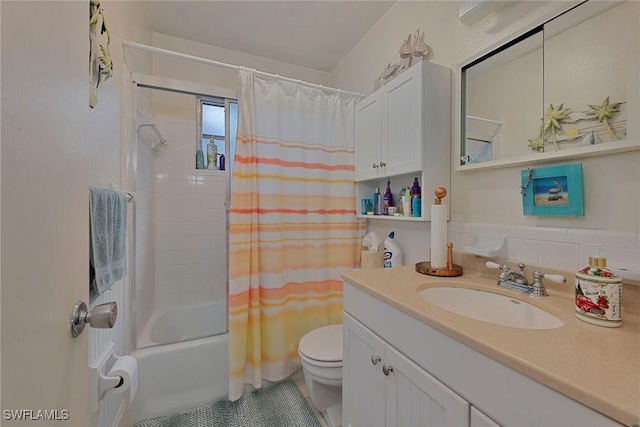 full bathroom featuring vanity, shower / bath combination with curtain, and toilet