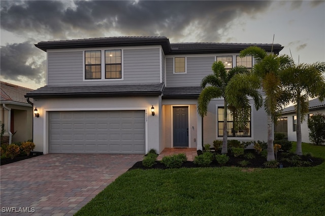 view of front of property with a front lawn and a garage