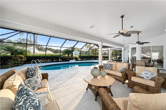 view of swimming pool featuring ceiling fan, an outdoor hangout area, a patio area, and glass enclosure