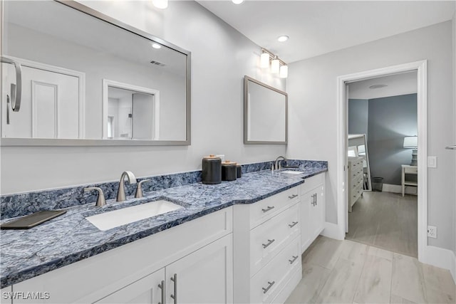 bathroom featuring hardwood / wood-style flooring and vanity