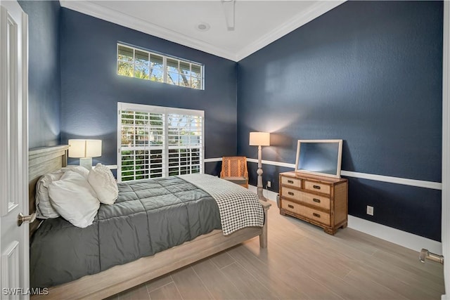 bedroom featuring hardwood / wood-style flooring and crown molding