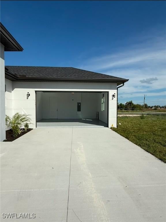 view of property exterior with a garage and a yard