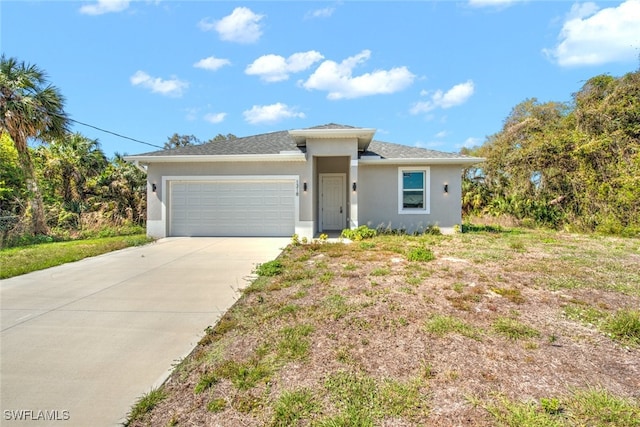 view of front of property with a garage, concrete driveway, and stucco siding