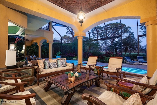 patio terrace at dusk with a lanai and an outdoor hangout area