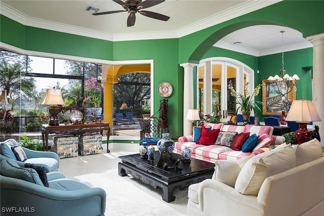 living room with ornamental molding, ornate columns, and ceiling fan with notable chandelier