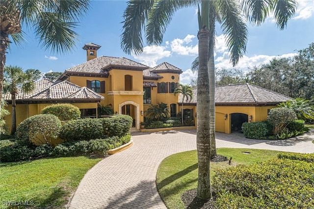 mediterranean / spanish house with a front lawn