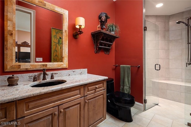 bathroom with tile patterned floors, vanity, toilet, and walk in shower