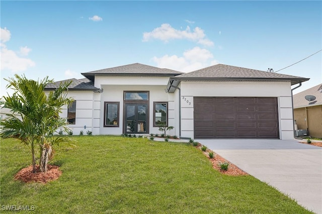 prairie-style house with a garage and a front yard