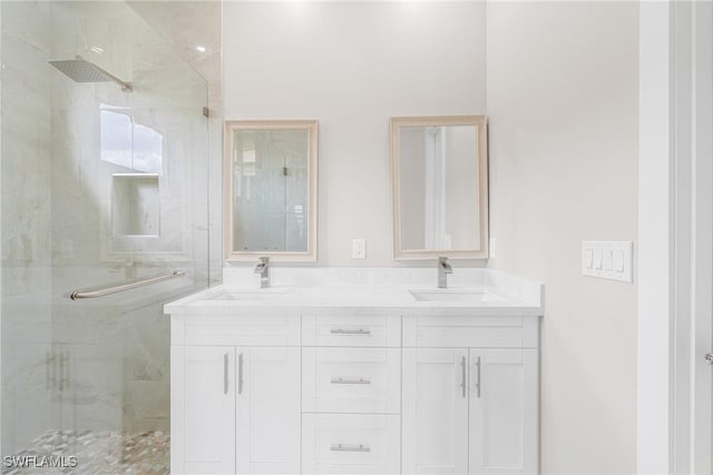 bathroom featuring vanity and a shower with shower door