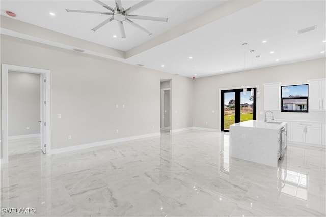 unfurnished room featuring sink and ceiling fan