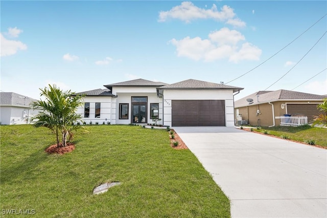 view of front facade with a garage and a front lawn