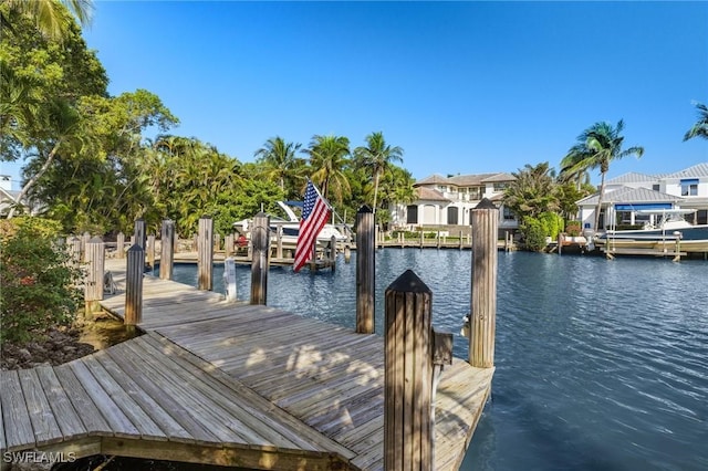 view of dock featuring a water view and a residential view