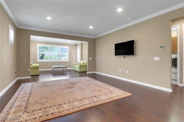 unfurnished room with ornamental molding, dark wood-type flooring, and washer / dryer