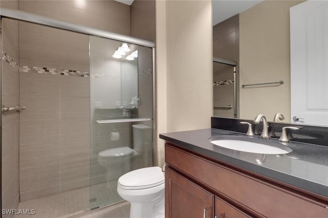 bathroom with vanity, toilet, and walk in shower