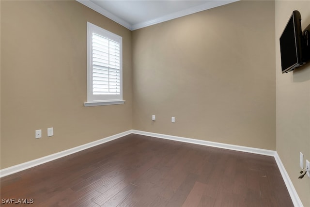 empty room featuring ornamental molding and dark hardwood / wood-style floors