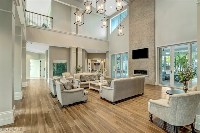 living room with a fireplace, a wealth of natural light, and hardwood / wood-style floors